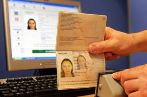 Une personne de l'Imprimerie nationale à Flers-en-Escrebieux prés de Douai contrôle, le 12 avril 2006, dans l'atelier de fabrication le nouveau passeport biometrique, obligatoire pour se rendre aux Etats-Unis la production doit débuter jeudi sur le site de Flers-en-Escrebieux. An employee of the state Printing Company in Flers-en-Escrebieux, near Douai, Northern France displays 12 April 2006 a sample of the new biometric pasport which production will start, 13 April. France's own roll-out of the new passports was held up because of a labour dispute sparked by the interior ministry's decision to ask a private company to produce the new passports instead of the state printing firm. Currently, thousands of French citizens who have had new passports issued since October last year without microchips containing facial data have had to apply for visas for travel to the United States, a process that takes several months.    AFP PHOTO PHILIPPE HUGUEN